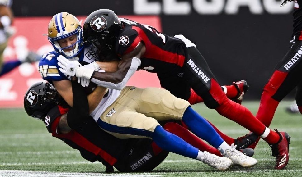 Winnipeg Blue Bombers' Greg McCrae (29) and Brady Oliveira (20