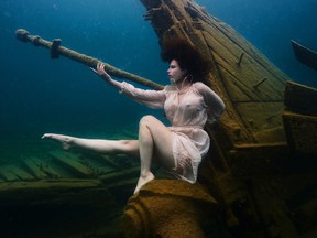 Brantford model Ciara Antoski poses at the bow of a shipwreck at Tobermory in a photo shoot with Hamilton photographer Steve Haining in June 2021. The shoot set a Guinness World Record at 21 feet for 16 minutes.  PHOTO BY STEVE HAINING