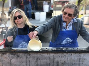 Kirsty DeIure, left and Debbie Orban whip up pancakes for guests at the 63rd Chinook Centre Stampede Breakfast on Saturday, July 8, 2023. They are only two of the thousands of volunteers who help make Stampede a special event every year, both on and off the grounds. Val Fortney photo.