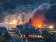 Smoke and fire rise over the town of Lac-Mégantic after a train carrying crude oil derailed and exploded in Lac-Megantic, 270 kilometres east of Montreal on July 6, 2013.