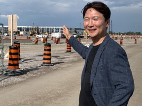 NextStar Energy CEO Danies Lee points out progress on construction of the module plant at the company's massive EV battery plant site in Windsor on Friday, July 28, 2023.