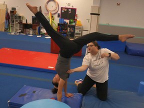 Gymnastic coach helps woman spin
