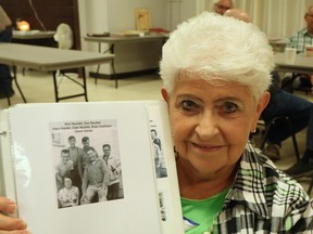 Grey-haired woman holding a photo album