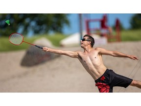 Randy Cook, of Woodstock, reaches with all he's got for the shuttlecock as he plays badminton with his buddy, Bryan Dixon, also of Woodstock, on the main beach in Port Stanley on Wednesday, July 19, 2023. (Mike Hensen/The London Free Press)