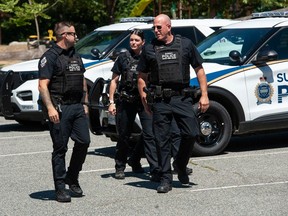 Surrey Police Service members Wednesday, July 19, 2023. Solicitor General Mike Farnworth announced earlier in the day that the SPS would be taking over from the RCMP as the primary police force in the city.
