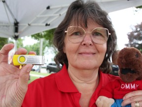 Dawn Gark with the Sarnia Moose Lodge chapter holds a thumb drive used in the lodge's Child Find program