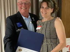 Keith Jones presents Port Dover resident Jennifer Rodger with a Paul Harris Fellow on behalf of the Rotary Club of Norfolk Sunrise. Rodger was honoured for her work in assisting Ukrainian refugee families as they settle in Norfolk County. CONTRIBUTED PHOTO