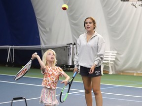 Instructor Mya Nebre works with Ella Bulbring, 6, on her serve at a tennis camp at the Sudbury Indoor Tennis Centre in Sudbury, Ont. on Monday July 17, 2023. The tennis camp is for children aged 6-14 who want to learn to play or improve their tennis skills. John Lappa/Sudbury Star/Postmedia Network
