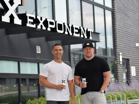 London-based Exponent Energy co-founders Matt Stirling, left, and Mike Pullam enjoy a drink in front of their new office at 104-320 Thames St. (Calvi Leon/The London Free Press)