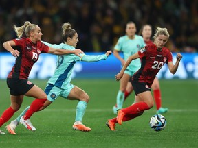 Katrina Gorry of Australia competes for the ball against Adriana Leon and Cloe Lacasse of Canada during the FIFA Women's World Cup Group B match between Canada and Australia at Melbourne Rectangular Stadium on July 31, 2023 in Melbourne, Australia.