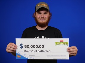 Brett O'Neil, 18, with his $50,000 cheque on Tuesday, Aug. 15, 2023, at the OLG Prize Centre in Toronto after winning OLG’s Instant Crossword game.
