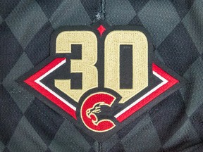 The numbr 30 in a diamond, fronted by the Prince George Cougars logo.