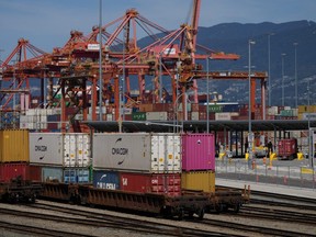 A transport truck carries a cargo container to the Centerm Container Terminal at port in Vancouver on Friday, July 14, 2023.