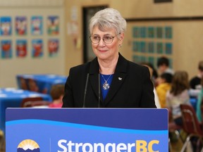 BC Finance Minister Katrine Conroy answers questions from reporters after serving up a hot lunch for students at Ruth King Elementary during a photo-op ahead of the budget while in Langford, B.C., on Feb. 27, 2023.