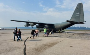 People in Fort Smith, N.W.T. board a Hercules aircraft operated by the Canadian Armed Forces before flying to Fort McMurray on Aug. 14, 2023. Image supplied by Canadian Armed Forces