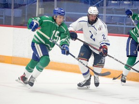 Ethan Larmand (15) of Team Green and Nolan Jackson (2) of Team White race for a puck during a Sudbury Wolves training camp scrimmage at Sudbury Community Arena on Thursday, August 31, 2023.