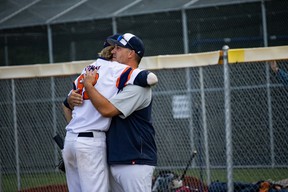 Jayden Conway of Team Fort McMurray hugs his coach, Joey Iannetti, after his final game with the Fort McMurray Oil Giants at the 2023 18U National Baseball Championships at Ross Hennigar Park on Sunday, August 20, 2023. Vincent McDermott/Fort McMurray Today/Postmedia Network