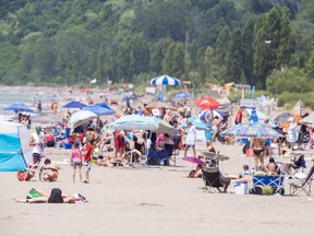 The main beach was populated with people and beach umbrellas in Port Stanley, Ontario on Monday July 24, 2023. Photo by Derek Ruttan/London Free Press/Postmedia Network