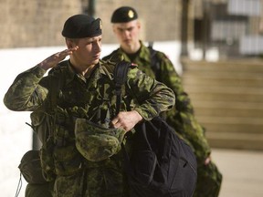 Jamie Boon, a reservist from Stratford, salutes as he passes the RCR monument at Wolseley Barracks on April 4, 2012. (Mike Hensen/The London Free Press)