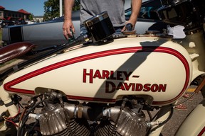 People look at a classic Harley Davidson motorcycle at the Acden Show and Shine in Fort McMurray on August 13, 2023. Vincent McDermott/Fort McMurray Today/Postmedia Network