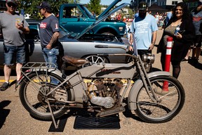 People look at a classic Harley Davidson motorcycle at the Acden Show and Shine in Fort McMurray on August 13, 2023. Vincent McDermott/Fort McMurray Today/Postmedia Network