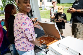Staff from The Alley serve pizza at Fort McMurray Heritage Village for the Empty Bowls Festival on August 20, 2023. The annual fundraiser benefits the Wood Buffalo Food Bank. Vincent McDermott/Fort McMurray Today/Postmedia Network