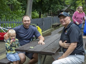 David Vujasinovich (right), community development coordinator for the City of Brantford visits with Aleks Ryzel and his five-year-old son Kyle -- recent immigrants from Ukraine -- during a Newcomers Welcome Day at Mohawk Park in Brantford on Wednesday August 23, 2023.