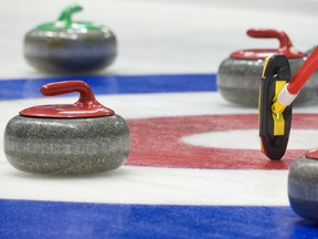 Stock photo of curling stones and broom in house