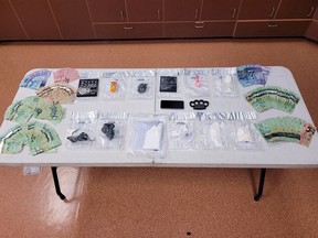 Drugs, weapons and cash seized during the execution of a search warrant in Napanee, Ont., on Thursday, August 10, 2023.