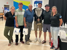 Curling team with trophy