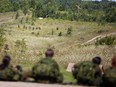 Soldiers from #1 Canadian Brigade Group look on as a live-fire drill is conducted in the field as part of Arrowhead Guardian 2023 at the 4th Canadian Division Training Centre in Meaford on Tuesday. Greg Cowan/The Sun Times