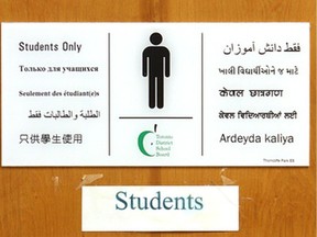 This 2008 file photo shows a washroom sign in multiple languages at Thorncliffe Park Public School in Toronto.