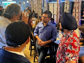 Liberal leadership hopeful Yasir Naqvi chats with supporters during a meet-and-greet at Tandoori Tastes in downtown Sudbury