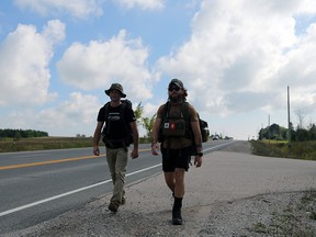 Arden Caplan (left) and Jon Aldworth rucking on Highway 26 from Meaford to Owen Sound on Friday, Aug. 25, 2023, as part of the Ruck 2 Remember Road to Recovery event in support of homeless veterans. Greg Cowan/The Sun Times