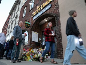 People stop to pay tribute outside of the Sharif Rahman's restaurant in downtown Owen Sound during a walking vigil on Sunday, Aug. 27, 2023. Greg Cowan/The Sun Times