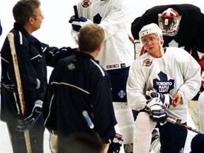 Leafs scout Garth Malarchuk (left) and Leafs development coach Paul Dennis talks with Carlo Colaiacovo in 2001.