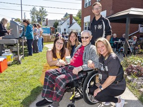 Dover Cliffs long-term care home resident Bill Spain is surrounded by educators from Holy Trinity Catholic High School educators (from left) Ally Bell, Brook Robinson, Jacolbie Barber, and Melissa Brown.  on Friday September 15, 2023 in Port Dover, Ontario.