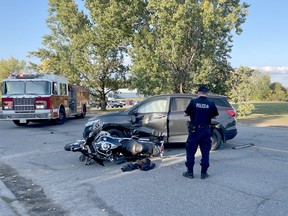 An officer from the Greater Sudbury Police Service investigates a collision involving an SUV and a motorcycle on Church Street in Garson, Ontario on Saturday evening, September 23, 2023. Police, firefighters and paramedics responded to the collision near the intersection with Falconbridge Road and closed the street to traffic in both directions. No information on injuries was immediately available.