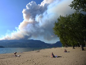 Smoke from the McDougall Creek fire is seen over Okanagan Lake from Kelowna, B.C., on Thursday, Aug. 17, 2023.
