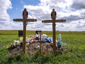 The graves of Thomas Burns and Carol Burns, who were killed in the 2022 mass stabbing event, are shown at the cemetery on the grounds of St. Stephen's Anglican Church in James Smith Cree Nation, Sask., Wednesday, August 9, 2023. Members of a Saskatchewan First Nation are to quietly gather today to mark the one-year anniversary of a mass stabbing.