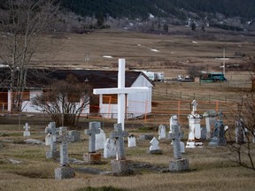 A cemetery and a boarded-up abandoned building are seen on the former grounds of St. Joseph's Mission Residential School, in Williams Lake, B.C., on Wednesday, March 30, 2022.