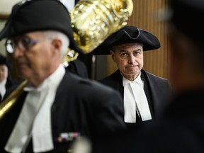 Speaker Anthony Rota, right, walks into the House of Commons during the Speaker's Parade on Parliament Hill in Ottawa on Monday, Sept. 25, 2023. Rota says he is deeply sorry that he has offended many people by praising a member of a Nazi unit as a Ukrainian war hero.