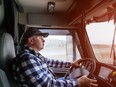 Driver in cabin of big truck on highway