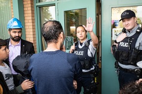 Police officers stop protesters from entering the Fort McMurray Public School Division during the 1 Million March 4 Children on September 20, 2023. Vincent McDermott/Fort McMurray Today/Postmedia Network