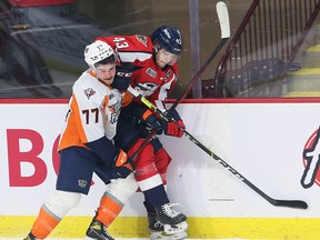 Zacharie Giroux, left, of the Flint Firebirds tangles with Louka Henault of the Windsor Spitfires on Sunday, January 16, 2022 at the WFCU Centre in Windsor.