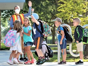 A pupil at Tweedsmuir elementary school jumps for joy after teacher Trish Pokok tells a group of youngsters what classroom they have been assigned to on the first day of school on Wednesday, Sept. 7, 2022. (DALE CARRUTHERS/The London Free Press)