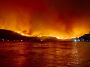 File photo of the McDougall Creek wildfire in West Kelowna. (Photo by Darren HULL / AFP)