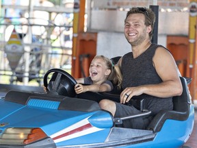 David Dyck of Langton, Ontario and his five-year-old daughter Lydia enjoy the bumper cars
