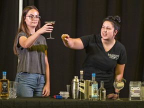 Jenna Edgar (left) holds an espresso martini during a cocktail demonstration by Jennifer Smith, a mixologist at Mann's Distillery in Brantford on Sunday