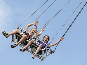 Best friends Leanna Robinson (left) and Reese Pragnell of Ayr enjoy a ride in high-flying swings